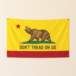 May include: A rectangular flag with a yellow background, a red stripe at the bottom, and a brown bear in the center. A red star is in the upper left corner. The text "DON'T TREAD ON US" is below the bear.