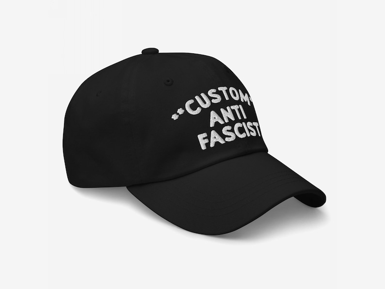 Side angle of the same personalized Anti-Fascist black dad hat showing the curved bill and white embroidery.