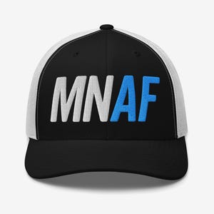 May include: Black and white trucker hat with the embroidered text "MNAF" in white and blue. The hat has a black brim and a white mesh back.