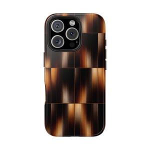 May include: A brown and black phone case with a tortoiseshell pattern. The case has a rectangular shape with rounded corners and a camera cutout. The design features vertical and horizontal lines creating a grid-like appearance.