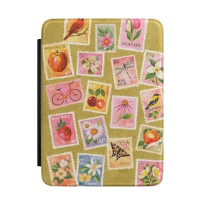 May include: A gold-colored tablet case featuring a collage of vintage postage stamps. The stamps depict various images, including a red bird, flowers, fruits, and a bicycle. The stamps are arranged on a textured background.