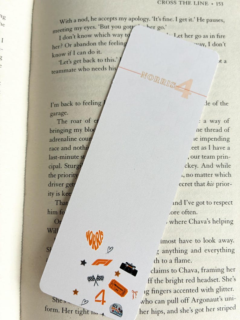 May include: White bookmark with the name "NORRIS" and the number "4" in orange. The bookmark features small orange and black racing-themed graphics, including a heart, stars, and a race car.