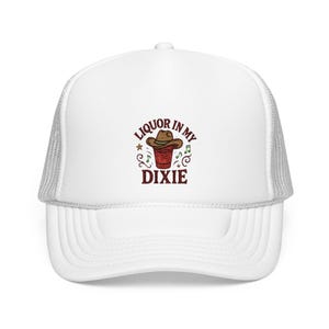 May include: White trucker hat with a red, white, and blue embroidered design that says "Liquor in my Dixie" with a cowboy hat on top of a red solo cup.