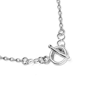 May include: A close-up of a silver necklace with a toggle clasp. The necklace chain is made of small, interconnected links. The clasp is a circular ring with a bar that slides through it to secure the necklace.