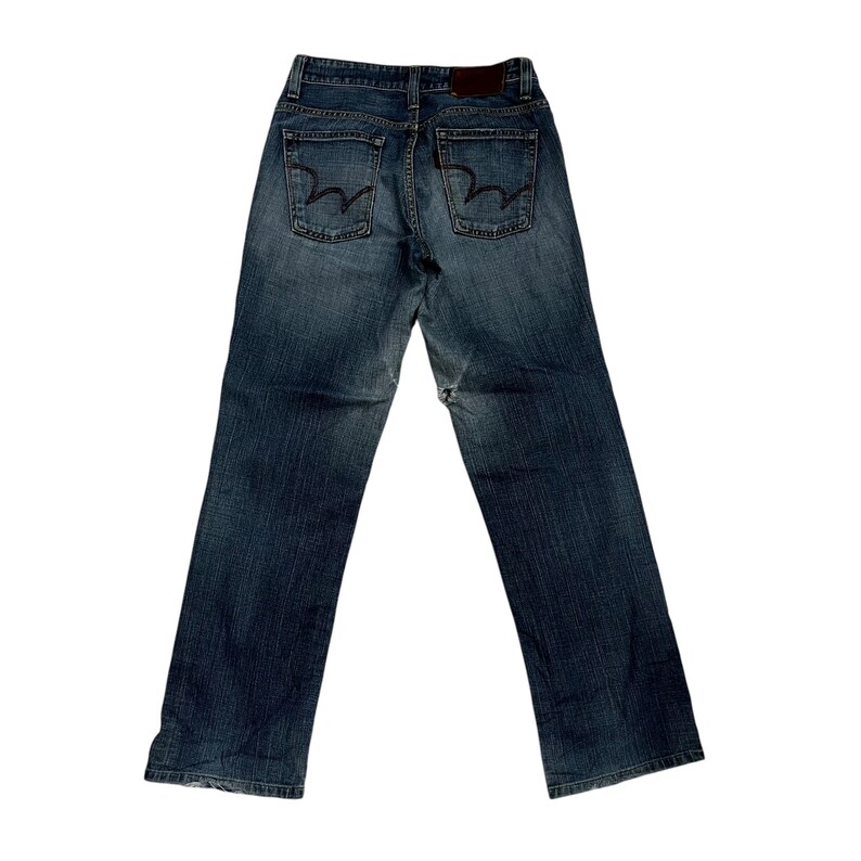Op de afbeelding: Achteraanzicht van een blauwe denim jeans met een klassiek vijf-zakken ontwerp. De jeans heeft een donkere wassing met vervaging en slijtage details. De achterzakken hebben een kenmerkend geborduurd ontwerp. Een bruine leren patch is zichtbaar bij de tailleband.