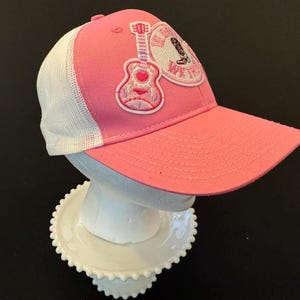 In Dolly We Trust Snapback Trucker Hat – Pink & White | Country Music Vibes | Adjustable Mesh Back | Cowgirl Style