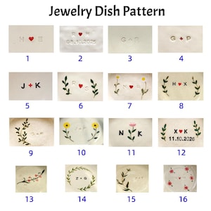 May include: A collection of white ceramic jewelry dishes with various designs. Each dish features initials, hearts, dates, and floral or leaf accents. The text "Jewelry Dish Pattern" is at the top.