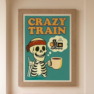 May include: Framed art print with a cartoon skeleton wearing a red headband, holding a coffee cup, and giving a thumbs-up. The words "CRAZY TRAIN" are at the top. A thought bubble shows a train. The background is teal.