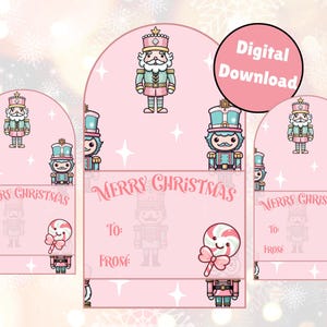 May include: Pink Christmas gift tags with a nutcracker and candy cane design. The tags have the text "Merry Christmas", "To", and "From". A digital download is indicated by a pink circle with white text.