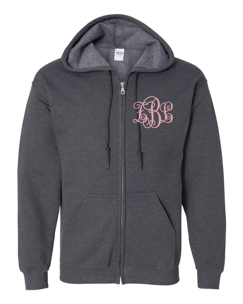 May include: A dark gray zip-up hoodie with a pink monogrammed "EBE" on the front.