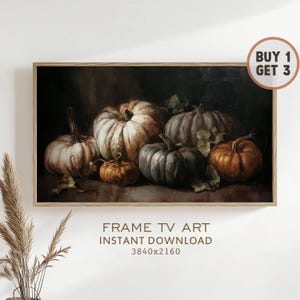 May include: A framed still life painting featuring a collection of pumpkins in various sizes and colors, including white, orange, and gray. The artwork has a dark background and includes the text "FRAME TV ART INSTANT DOWNLOAD 3840x2160".