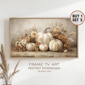 May include: A framed print featuring a still life of white pumpkins and fall flowers. The artwork has a neutral color palette with beige, cream, and orange tones. Text at the bottom reads "FRAME TV ART INSTANT DOWNLOAD 3840x2160".