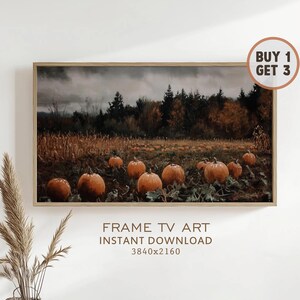 May include: A framed landscape print featuring a pumpkin patch with orange pumpkins in a field. The background shows a forest under a cloudy sky. The print includes the text "FRAME TV ART INSTANT DOWNLOAD 3840x2160".