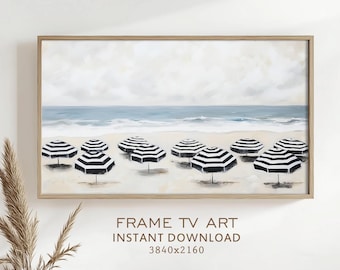 May include: A framed beach scene painting featuring black and white striped umbrellas on a sandy beach. The ocean and sky are painted in shades of blue and white. The text "FRAME TV ART INSTANT DOWNLOAD 3840x2160" is at the bottom.