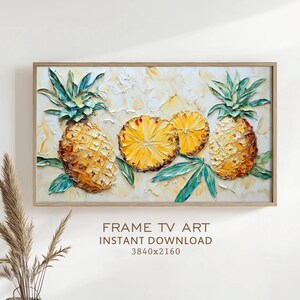 May include: A framed artwork featuring a textured painting of pineapples. The painting includes two whole pineapples, two pineapple slices, and green leaves against a cream-colored background. The text "FRAME TV ART INSTANT DOWNLOAD 3840x2160" is visible.