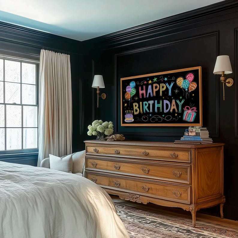 May include: A bedroom with dark walls and a wooden dresser. A framed chalkboard with the words "Happy Birthday" and colorful illustrations hangs above the dresser. The room also features a window, curtains, and wall sconces.
