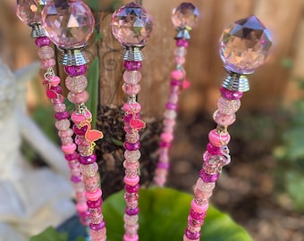 May include: Four pink and white beaded garden stakes with crystal ball toppers and flamingo charms.