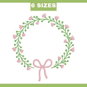 May include: A floral wreath design with pink flowers and green stems, accented by a pink bow at the bottom. The text "6 SIZES" is in a green rectangle at the top. The design is on a white background.