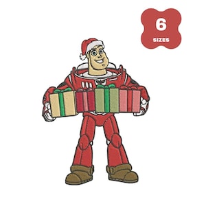 Op de afbeelding: Geborduurd ontwerp van een stripfiguur in een rood ruimtepak en kerstmuts, met ingepakte cadeaus. De afbeelding bevat een rood label met de tekst "6 SIZES". Het personage heeft een glimlachende uitdrukking en draagt bruine laarzen.