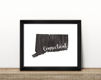 May include: Black and white print of the state of Connecticut in a black frame. The state is outlined in black with a watercolour wash. The word "Connecticut" is written in white cursive lettering.
