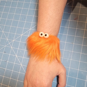 Fuzzy Facelets - Slap Bracelets with Character from All Hands Productions! (ORANGE)