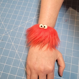 Fuzzy Facelets - Slap Bracelets with Character from All Hands Productions! (RED)