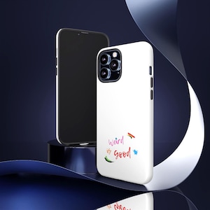 May include: White phone case with the text "Weird is good" in colorful script. A black smartphone is next to the case. The case has a camera bump and side buttons. The background is dark blue with a white ribbon.