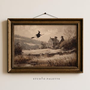 May include: Framed sepia-toned artwork depicting a witch on a broom flying over a rural landscape with a house. The artwork is in a gold-colored frame and is hanging on a white wall. The text "STUDIO PALETTE" is at the bottom.