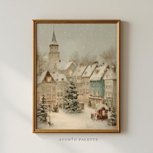 May include: A framed print of a winter village scene. The artwork shows snow-covered buildings, a Christmas tree, and a church steeple. The print is in a gold frame and features the text "STUDIO PALETTE" at the bottom.