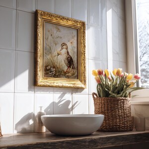 May include: A framed artwork featuring a duck in a field of flowers hangs above a white ceramic bowl. A woven basket holds yellow and red tulips. The scene is set in a bathroom with white tile and a wooden countertop.