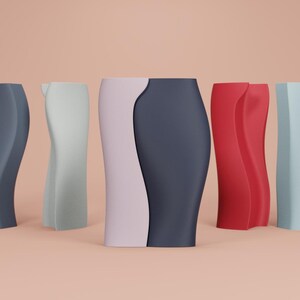 May include: A collection of six modern vases in various colors, including dark gray, light green, a combination of light pink and dark gray, red, and light blue. Each vase has a unique, curved design.
