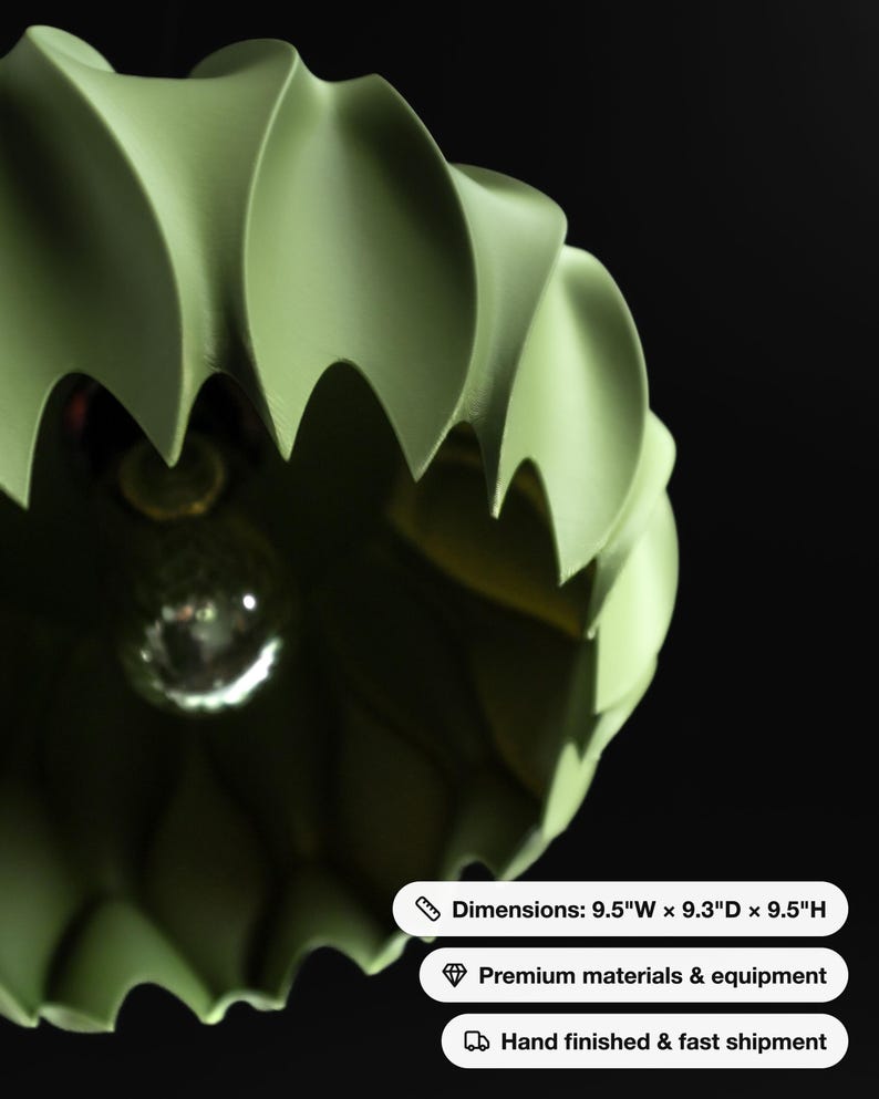 May include: A sage green pendant light fixture with a scalloped, ribbed exterior and a central light bulb. The fixture measures 9.5 inches wide, 9.3 inches deep, and 9.5 inches high, featuring a matte finish and a curved, petal-like design.