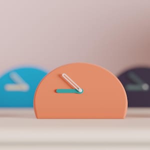 May include: A series of semi-circular analog clocks in various colors including green, blue, peach, purple, and dark gray. Each clock features a flat base and two hands indicating the time, arranged in a row with a shallow depth of field.