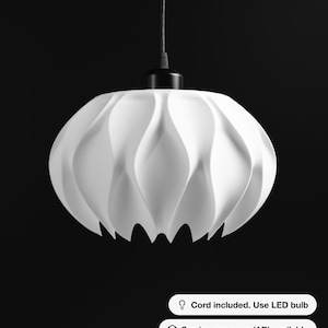 May include: A white pendant light fixture with a curved, petal-like structure suspended by a black cord. The fixture features a black top mount. Text on the image reads: Cord included. Use LED bulb, See in your room (AR) available, 40+ colors available.