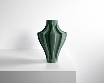 May include: A dark green vase with a matte finish, featuring a geometric, multi-faceted structure with vertical ridges that taper toward the narrow neck and base, creating a distinct, symmetrical, and angular silhouette.