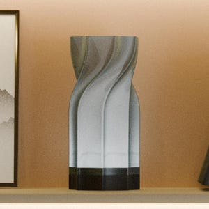May include: A cylindrical vase with a vertical twisted, spiraling texture in a light gray gradient finish. The base of the vase is a solid, dark charcoal gray band. The object features a smooth, matte surface with distinct, repeating vertical ridges.
