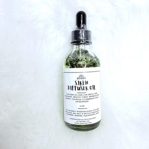 May include: A clear glass bottle of Siren Diffuser Oil with a black dropper cap. The label reads: Celstars, Siren Diffuser Oil, 2 oz, eco friendly biodegradable diffuser solution, sea salt and orchid fragrance, lavender, jasmine, aquamarine, resin.