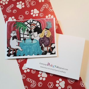 May include: A hand-painted greeting card featuring a white poodle, a woman in a purple dress, and a man in a black suit, all sitting at a table with wine glasses. The background is a pink and red room with a window and palm tree.