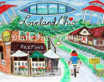 May include: A painting of a street scene in Loveland, Ohio. The painting features a red and white gazebo, a restaurant called Paxton's, a person riding a bicycle, and a sign that says "Road Xing". The painting is titled "Loveland Ohio" and signed "Diane Pape Designs".