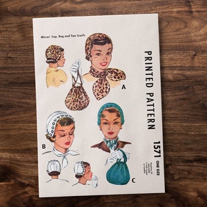 May include: A vintage sewing pattern for a cap, bag, and two scarves. The pattern is printed on a white sheet of paper with black text. The pattern number is 1571. The pattern is for one size.