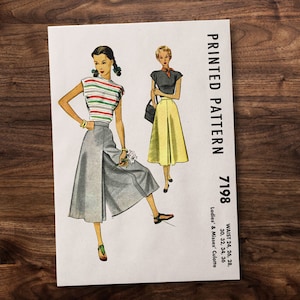 May include: A vintage sewing pattern for a culotte, printed on a white paper with black text. The pattern is for sizes 24 to 36 inches waist. The pattern shows two women wearing the culotte, one with a striped top and the other with a solid top.