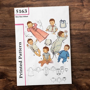 May include: A vintage sewing pattern for baby clothes, pattern number 5163, one size infant. The pattern includes instructions for a gown, a sleeper, a bib, and a set of pants and a shirt. The pattern is illustrated with drawings of babies wearing the clothes.