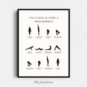 May include: Black framed print showing a yoga sequence titled "Salutation au Soleil A, Suryia Namaskar A." The print displays black silhouette figures demonstrating yoga poses with French titles. The bottom of the print has the text "YogArtdeVivre."