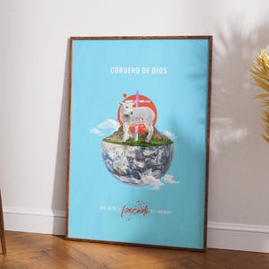 May include: A framed poster with a light blue background features a lamb standing on a grassy globe. The words "CORDERO DE DIOS" are at the top, with text at the bottom. A red circle and a purple cross are behind the lamb. The frame is brown.