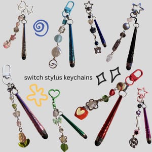 May include: A selection of switch stylus keychains, each with a unique design. The keychains feature styluses with decorative beaded chains, charms, and clasps. The text "switch stylus keychains" is visible in the image.