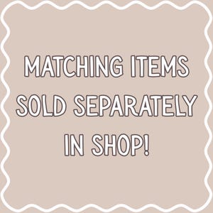 May include: A beige background with a white wavy border and text that reads "MATCHING ITEMS SOLD SEPARATELY IN SHOP!" in a bold, outlined font. The text is centered and clearly visible.