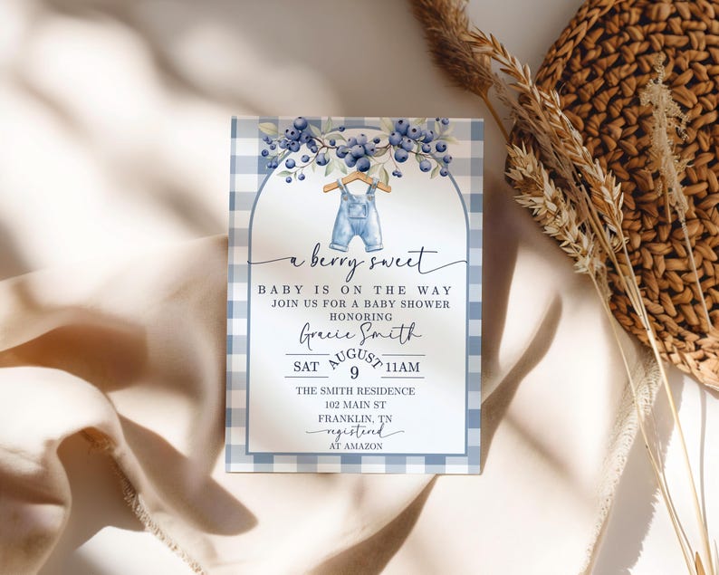 May include: Baby shower invitation with a blue and white gingham border. The invitation features the text "a berry sweet" and "Baby is on the way". It includes details for Gracie Smith's baby shower, including the date, time, and location.