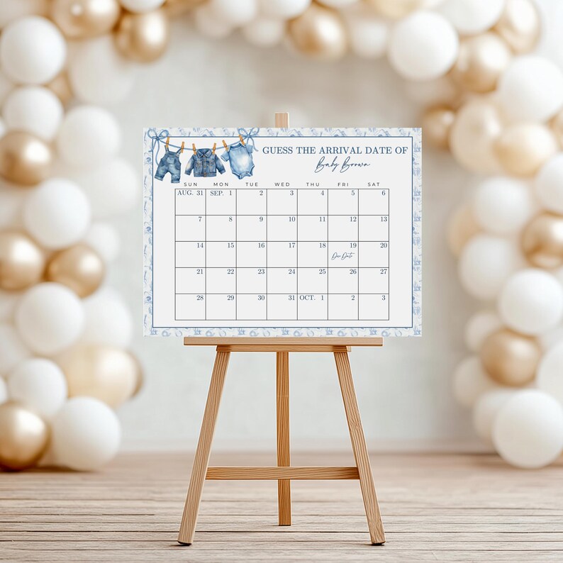 May include: A baby shower calendar on a wooden easel. The calendar is decorated with blue watercolor illustrations of baby clothes and the text "Guess the Arrival Date of Baby Brown." The calendar is surrounded by white and gold balloons.