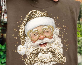 Papá Noel con estampado de leopardo PNG Diseño de sublimación navideña de moda Papá Noel glamuroso con manos en forma de corazón Purpurina dorada Imágenes prediseñadas navideñas Descarga Feliz y brillante