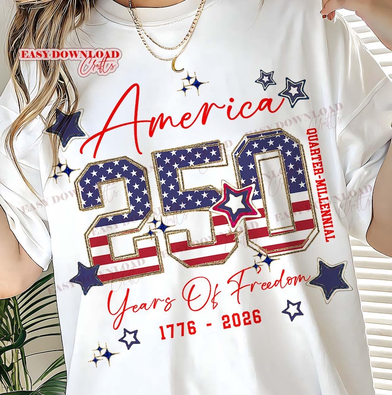May include: White t-shirt with a patriotic design celebrating America's 250th anniversary. The design features the word "America" in red script, the number "250" filled with a stars and stripes pattern, and the text "Years Of Freedom 1776-2026". Blue stars and a red and white star accent the design.